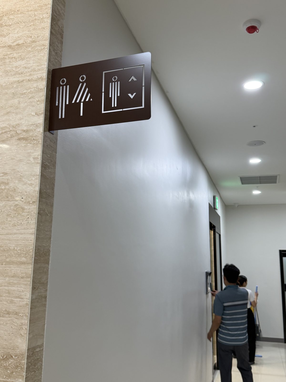 Projecting restroom and lift pictogram sign in the corridor