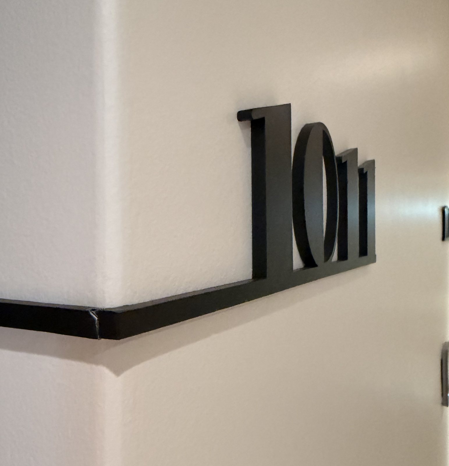 Room number wrapping around a corridor corner