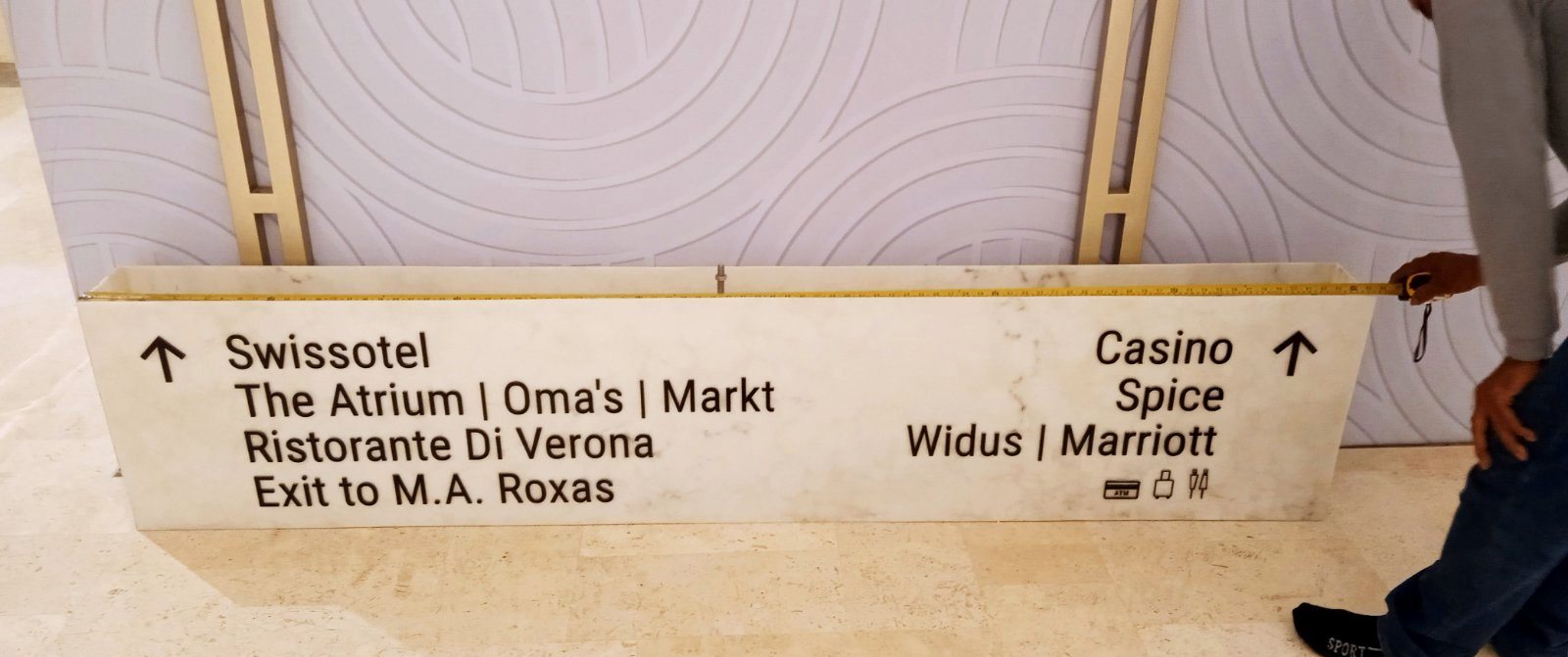 Wayfinding sign measured with a tape before installation