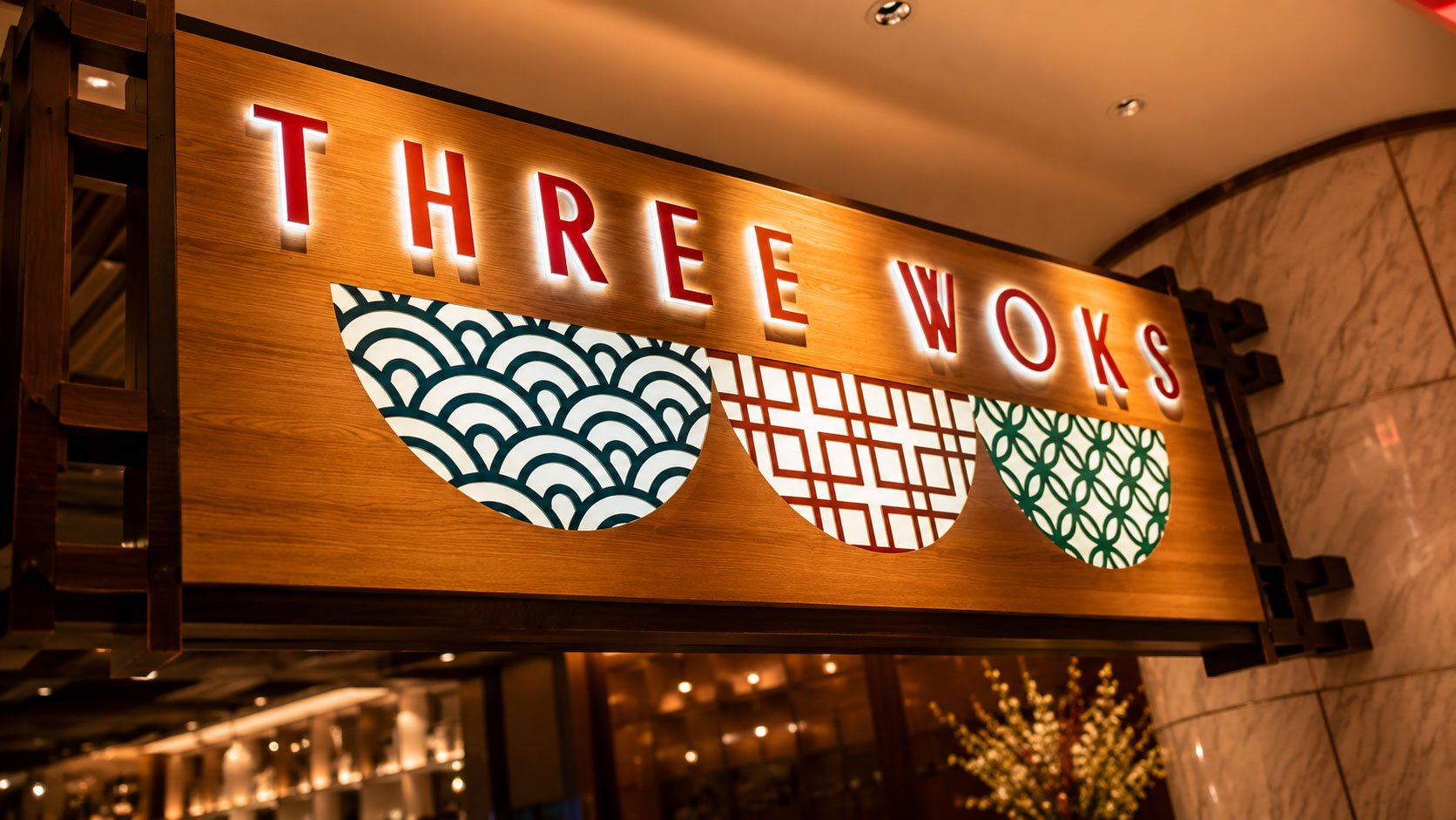 Three Woks finished sign, halo-lit letters and backlit bowl patterns